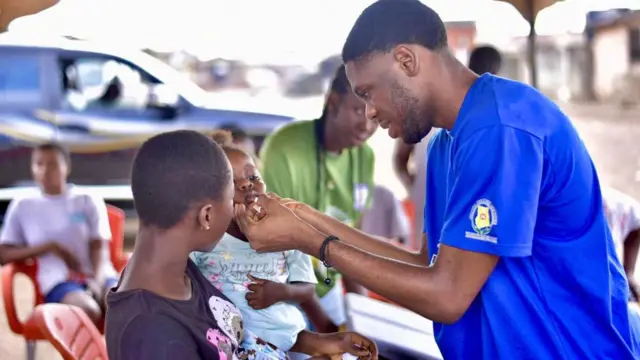 A man is vaccinating a child