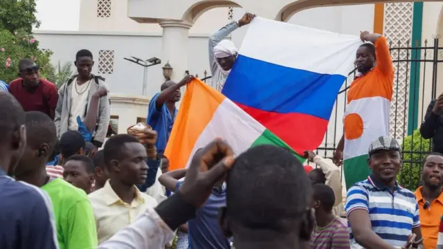 Homens na rua levantam bandeira da Rússia