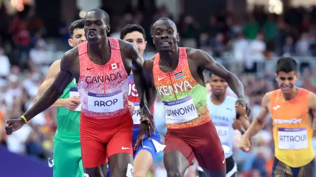 Marco Arop of Canada and Emmanuel Wanyonyi of Kenya are pictured straining forward for the finish line during the men's 800m final at the Paris 2024 Olympics