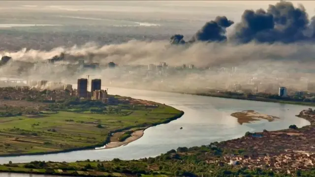 An aerial view of black smoke covering the sky above the capital Khartoum on 23 April
