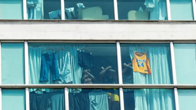 A picture of washing drying in the windows of the hotel in Panama City