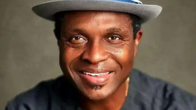 Arc Tonye Cole wear grey hat and black top