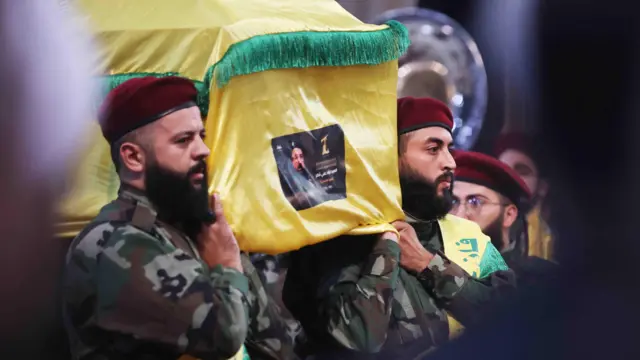 Hezbollah fighters carry the coffin of commander Fuad Shukr during his funeral in the southern suburbs of the Lebanese capital Beirut on 1 August 2024