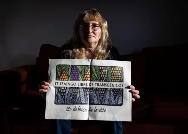 Sofía Gatica, holding a protest poster