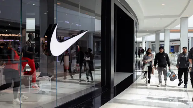Shoppers walk past a Nike store in the King of Prussia Mall, in King of Prussia, Pennsylvania
