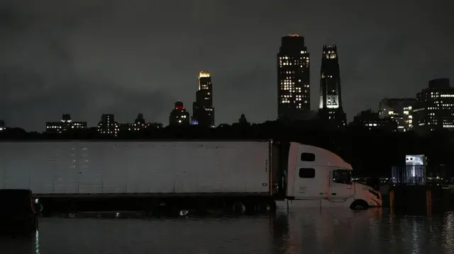 ニュージャージー州プレインフィールドで発生した洪水で浸水した道路とトラック。白い大型トラックのタイヤが水没している