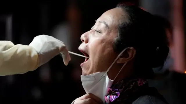 Une dame qui effectue le test covid