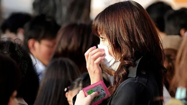 Una mujer con una máscara en su rostro.