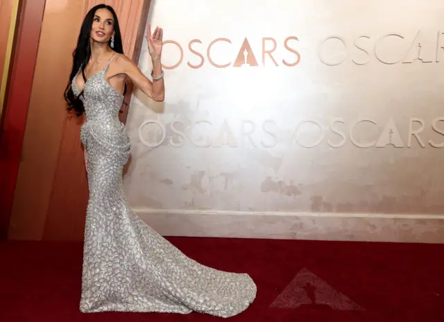 Demi Moore usou um vestido prateado e os cabelos soltos