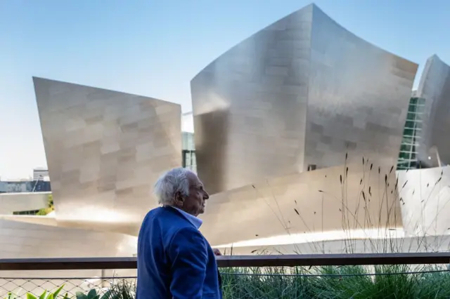 Famed architect Frank Gehry is photographed in an outdoor seating area at Sed Bar, part of the Conrad Los Angeles, a luxury Hilton hotel, within The Grand LA development, directly across from the Walt Disney Concert Hall, which Gehry also designed, in downtown Los Angeles, California, on Monday, June 20, 2022. (Photo: J.L. Clendenin/Los Angeles Times via Getty Images)