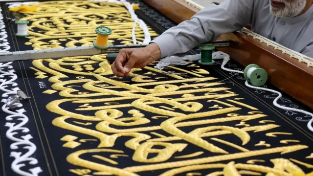 عامل يُعد كسوة الكعبة في أحد المصانع تحضيراً لموسم الحج السنوي في مكة المكرمة، المملكة العربية السعودية، 6 يوليو/ تموز 2022.