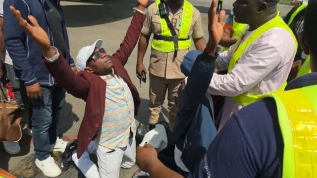 One Nigerian man wey just land Nigeria from South Africa kneel down
