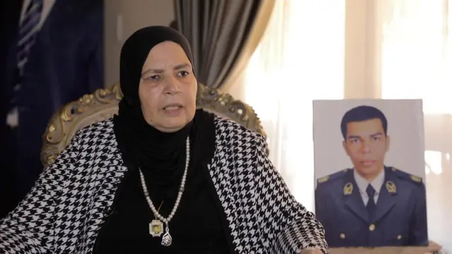 Wafaa holding a photo of her son Mustafa