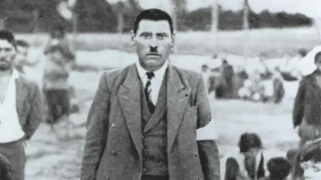 Photo of a Romani (potentially Jozef Kwiek) wearing an armband. The image dates to 1940 and was taken in Belzec camp (not the extermination camp though; in 1940, a temporary labour camp existed there)