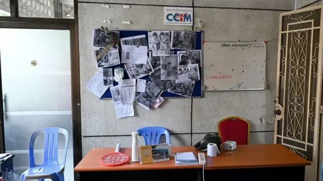 A journalist looks at pictures on the wall of an office of online media outlet Voice of Democracy (VOD) in Phnom Penh on February 13, 2023, after Cambodian Prime Minister said VOD would have its operating licence revoked. - Cambodia's strongman leader late on February 12 ordered the shutdown of one of the country's few remaining local independent media outlets after taking issue with a news report about his son. (Photo by TANG CHHIN Sothy and TANG CHHIN SOTHY / AFP) (Photo by TANG CHHIN SOTHY/AFP via Getty Images)