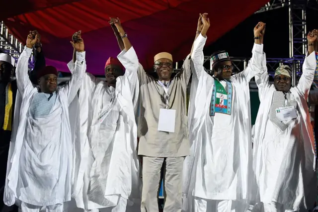 Tsohon shugaban APC, John Oyegun yana ɗaga hannun ƴan APC ciki har da marigayi Muhammadu Buhari.