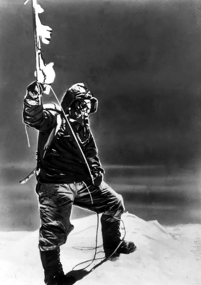 Sherpa Tenzing Norgay (1914 - 1986) holds an ice axe at the summit of Mt. Everest, Nepal, 1953