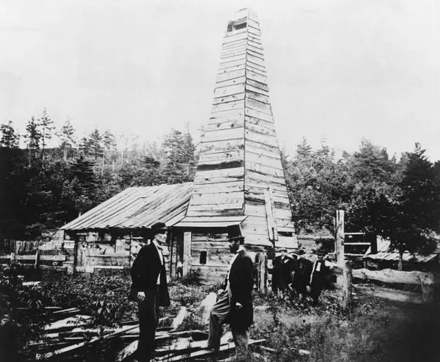 Видобуток нафти у Пеннсильванії у 1861 році. У циліндрі та фраку на передньому плані - Едвін Л. Дрейк - чоловік, який вигадав, як видобувати нафту 