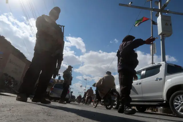 Pakistani security officials check people at a roadside checkpoint in Quetta, the provincial capital of Balochistan province