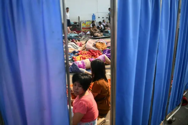 Earthquake victims lie on the ground of the compound of a hospital in Nay Pyi Taw on March 28, 2025, after an earthquake in central Myanmar.