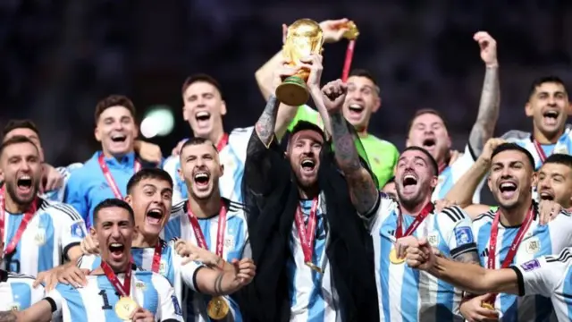 Lionel Messi lift World Cup trophy