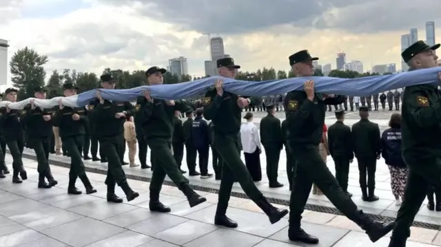 Soldados carregando enome bandeira