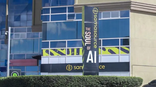 The exterior of an office block with the Sama sign on it. A slogan says: "The soul of AI"