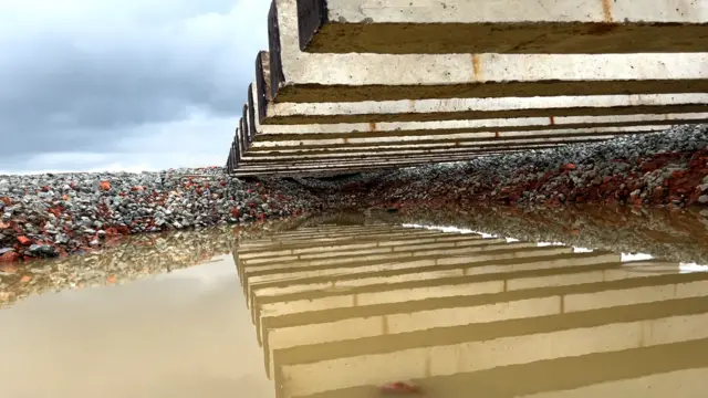 বানের পানিতে রেল লাইনের পাথর সরে সৃষ্টি হয়েছে গর্ত