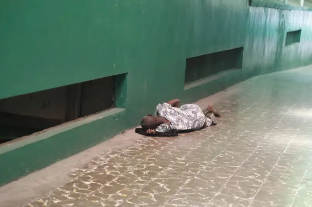 Persona durmiendo en el piso.