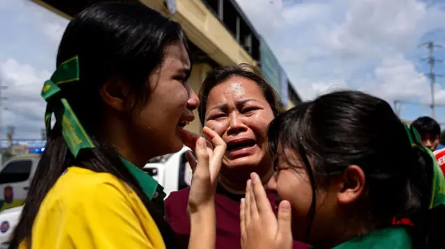 Relieved yet deeply shaken parents burst into tears as they picked up their children who safely fled the scene of a mass shooting at Debsirin Nonthaburi School in Plai Bang District, Nonthaburi Province.