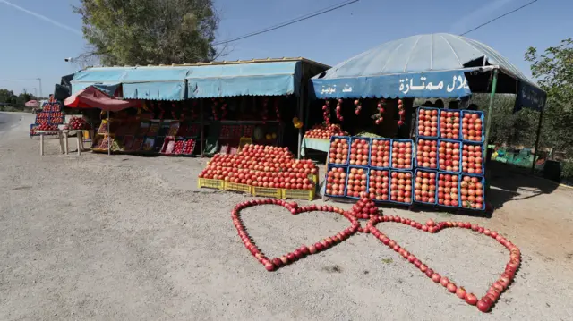 Mai saida Kayan marmari a wurin sha karawa ma Tastour a kaşar Tunisia, ya jera dan içen Ruman a ranar Lahadi 13 Oktoba 2024, ya kayata wurin da alamar zuciya da ke nuna soyayya.