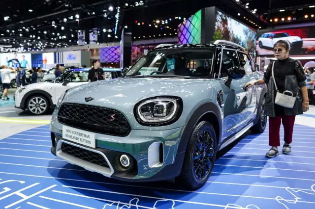 A visitor is inspecting the MINI Cooper Countryman Highlands Edition car on display at the 45th Bangkok International Motor Show in Nonthaburi Province, on the outskirts of Bangkok, Thailand, on March 30, 2024. 