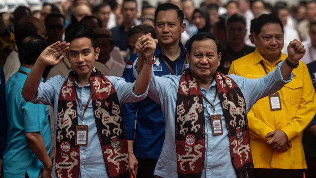 Prabowo Subianto (kanan) dan Gibran Rakabuming Raka (kiri) melambaikan tangan