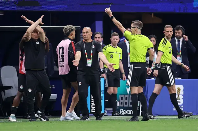 Hossam Hassan Manager / Head Coach of Egypt makes a cross arm gesture as Referee Francois Letexier shows a yellow card during the FIFA World Cup 2026 Round of 16 match between Argentina and Egypt at Atlanta Stadium on July 07, 2026 in Atlanta, Georgia.