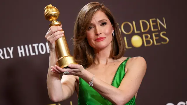 Rose Byrne hold up her Golden Globe