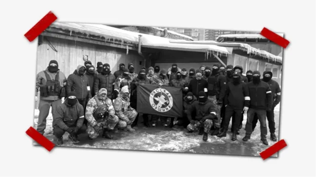 مردان نقاب‌پوش در کنار بنر جامعه روسی.