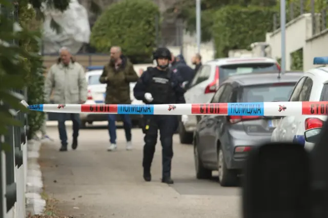 Uviđaj u dvorištu Zdravka Čolića na Dedinju, policijska traka i policajac u uniformi