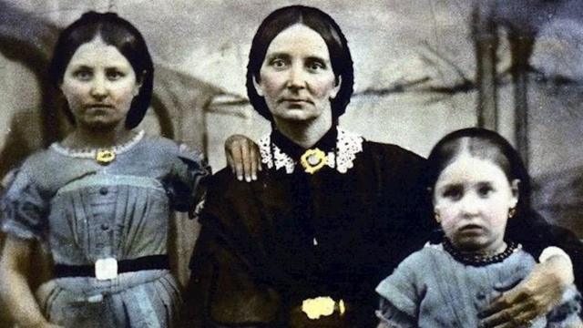 A colourised black and white picture of Hannah Hall, a Victorian woman and her two children in 1862