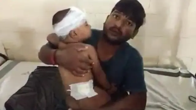 Her son - seen here wit im father - suffer wounds to im head