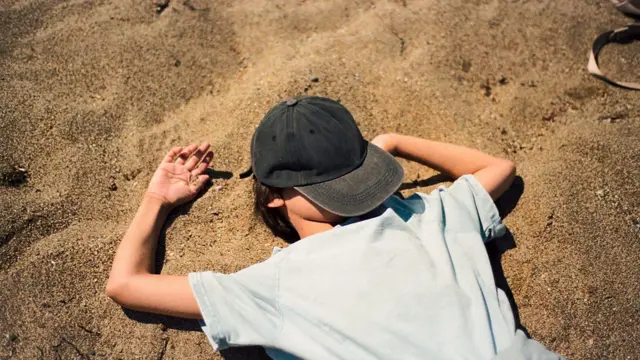 टोपी डोक्यावर ओढलेला व्यक्ती