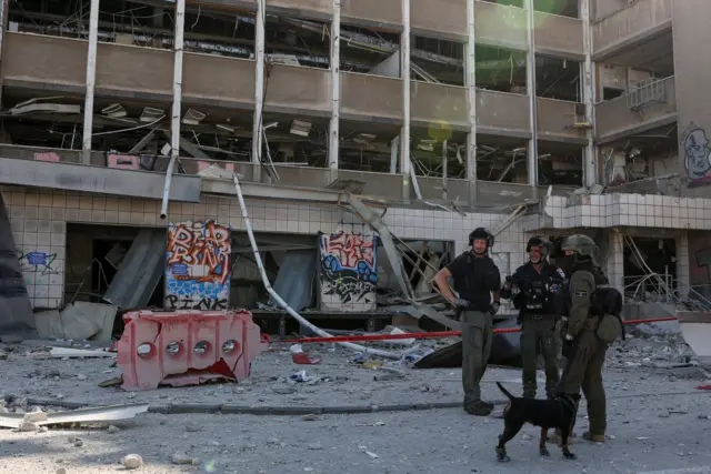 Emergency personnel work at an impact site following Iran's missile strike on Israel, amid the Iran-Israel conflict, in Haifa, Israel, June 20, 2025. REUTERS/Florion Goga