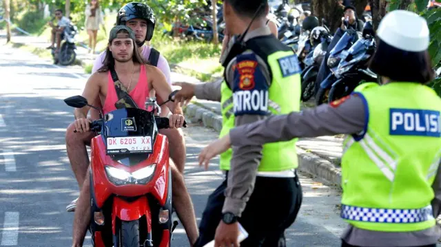 Personel Satlantas Polres Badung menghentikan warga negara asing (WNA) yang melanggar aturan lalu lintas di kawasan Canggu, Badung, Bali, Kamis (9/3/2023).