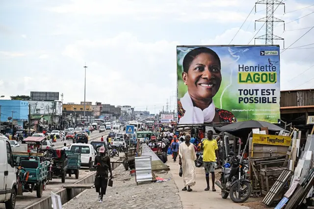 Vue générale d'une affiche de campagne de la candidate à la présidentielle du Groupement des Partenaires Politiques pour la Paix (GP-PAIX), Henriette Lagou, dans le quartier de Yopougon à Abidjan, le 12 octobre 2025. 