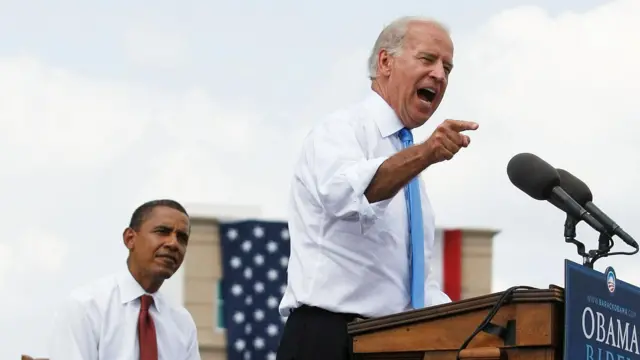 Biden pointing and giving a speech, as Obama listens 