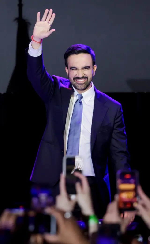 تصویر آقای ممدانی درحالیکه دست راستش را بالا برده است