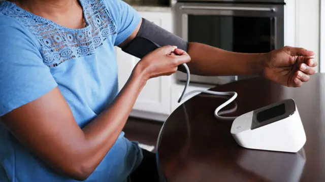 A woman checking her blood pressure