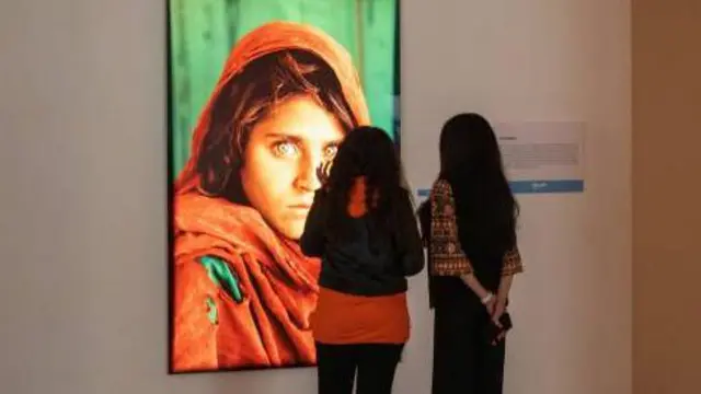 دوه مېرمنې د شربت ګلې د انځور لیدو ته ولاړې دي.