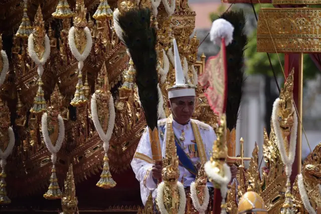 มนต์ชัย นิลนฤนาท เจ้าพนักงานรถยนต์พระที่นั่งถวายงานพระบาทสมเด็จพระปรมินทรมหาภูมิพลอดุลยเดช ทำหน้าที่เป็นสารถีถือแพนหางนกยูง พระมหาพิชัยราชรถ