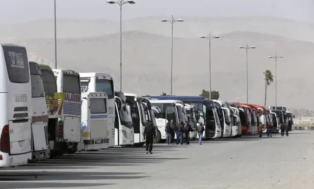 حافلات تابعة للحكومة السورية تنتظر خارج حرستا، شرقي الغوطة الشرقية.