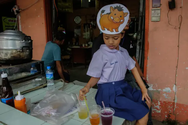 A young Thai girl wears a wild boar hat  Chiangrai Prachanukroh Hospital on July 10, 2018 in Chiang Rai